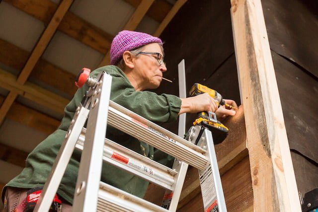 A student puts on siding like the building apprenticeship students may do