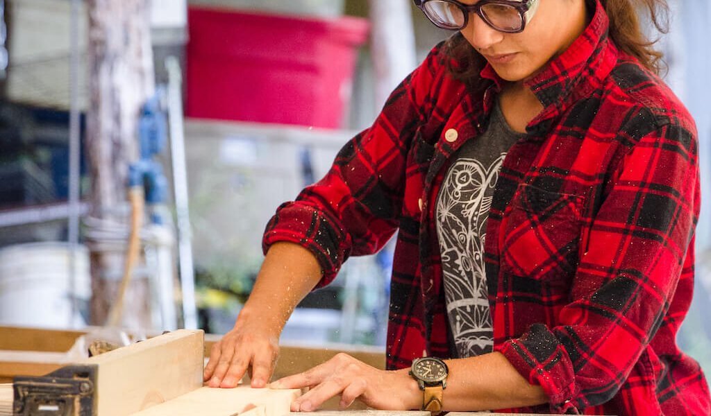 woman uses table saw during all genders carpentry class