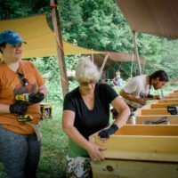 Three students work together during advanced all genders carpentry class
