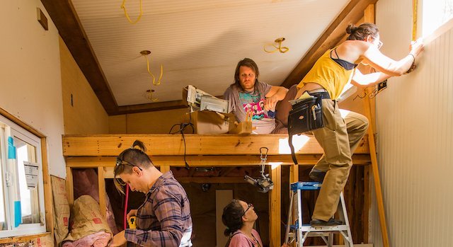 Four students work in tiny house during building apprenticeship