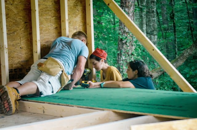 men and women carpentry students installing a floor system