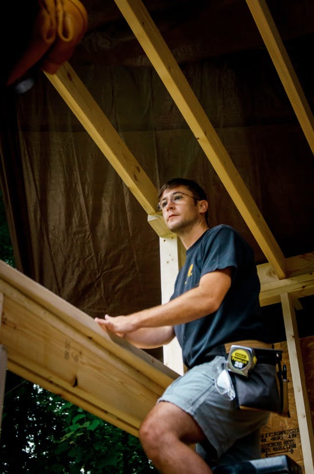 male carpentry student building a wall