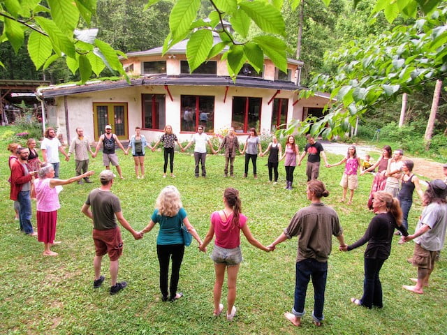Earthaven Ecovillage Wild Abundance Partner. Students stand in a circle outside of the Earthaven campus.