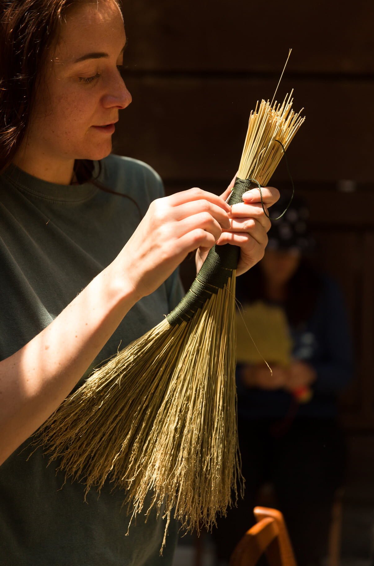 rewilding woman making a whisk broom