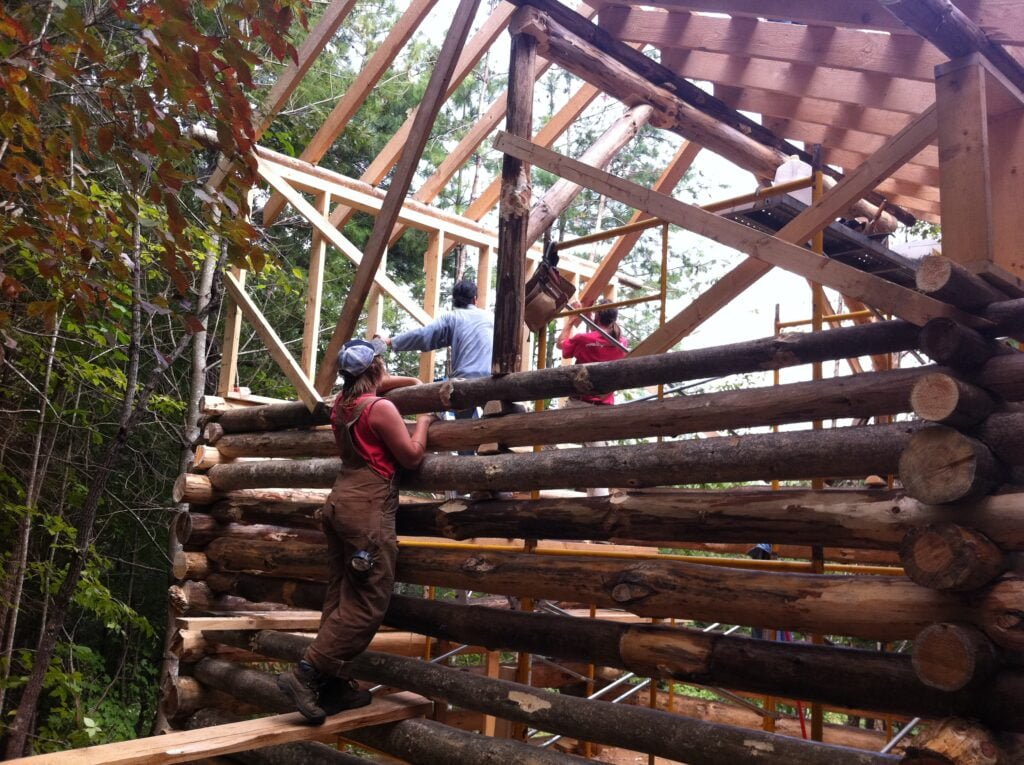 Photo of Natalie Bogwalker's original sustainable log cabin tiny home mid-construction