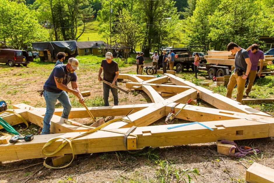 students in a Timber Framing Class at Wild Abundance prepare to raise a bent while building the teaching pavilion for the new campus
