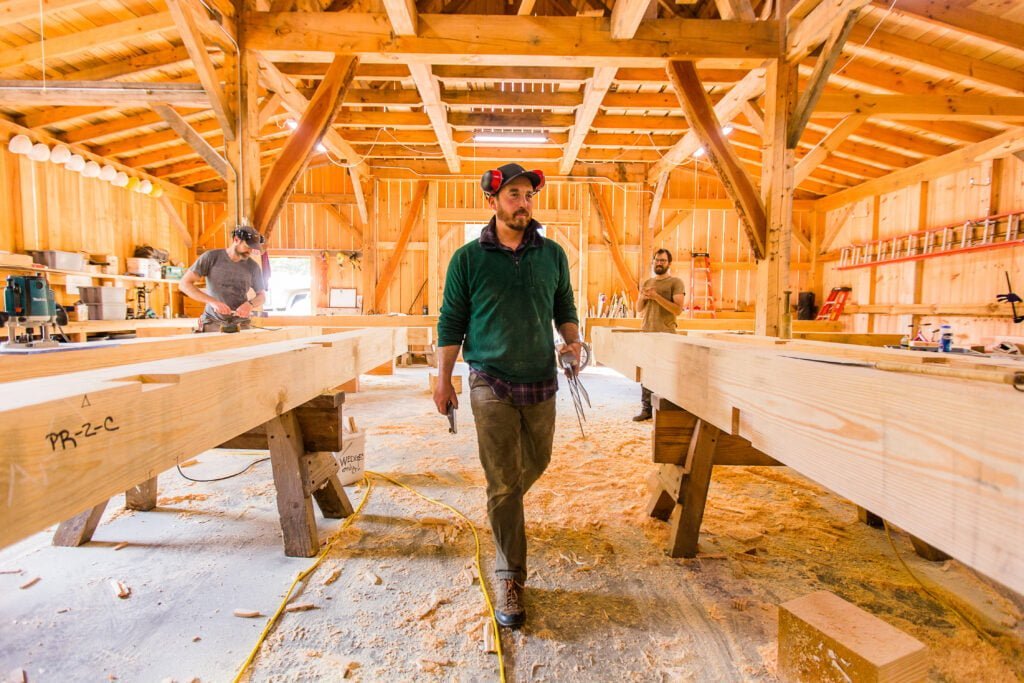 Brian Snedecker, the Timber Framing instructor, walks through his beautiful workshop as students work on preparing timbers for a building project at Wild Abundance.