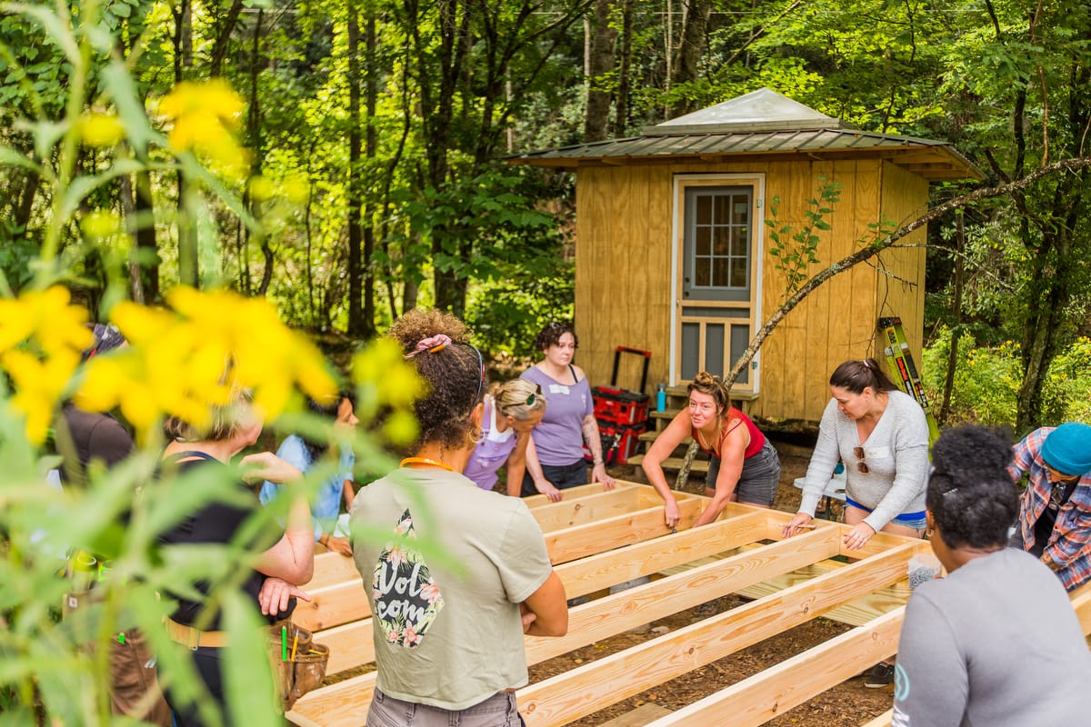 144_WAC sleeping structures advanced 2025-©SarahTew Students learn to build a floor system for small structure at a Women's Advanced Carpentry workshop at Wild Abundance in North Carolina