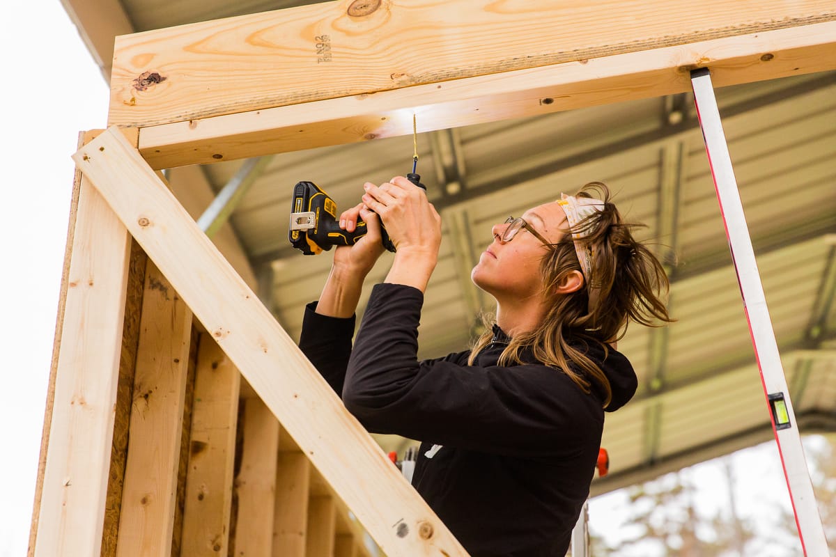 A woman building a Tiny Home in a 10 day DIY carpentry workshop at Wild Abundance