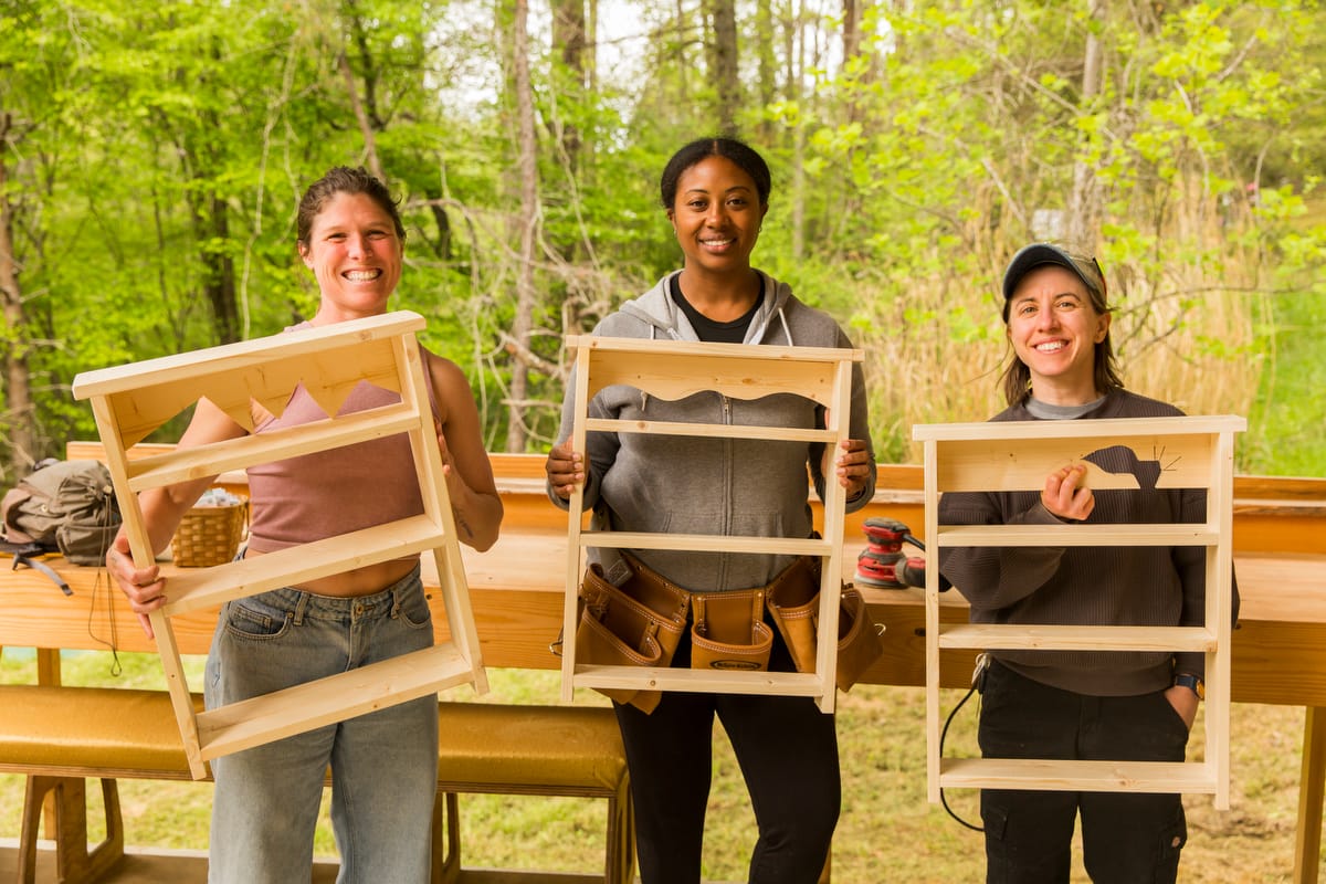 2025-84 Students mile for a picture with their personal projects on the last day of a 4 day Women's Basic Carpentry 4 day workshop at Wild Abundance in North Carolina