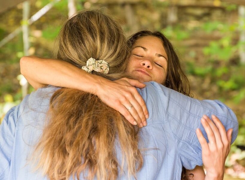 two women hug at the end of a healing women's rewilding retreat at Wild bundance