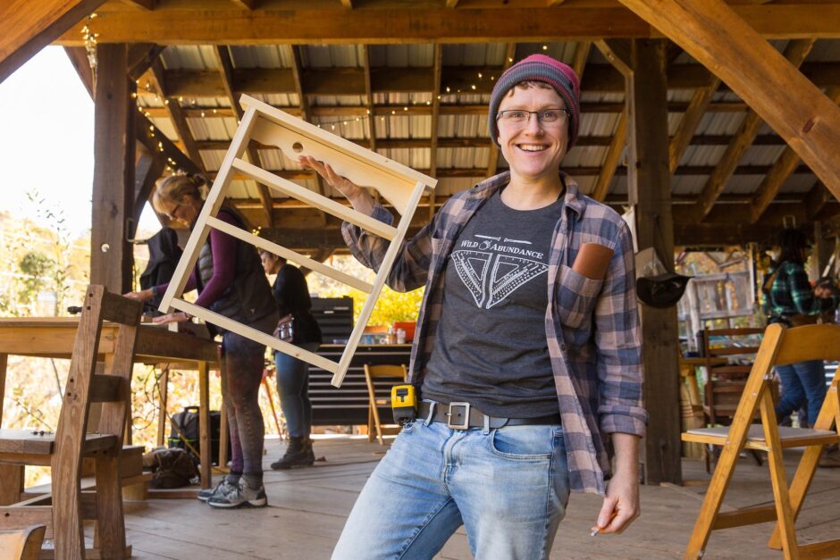A student shows off their final project from basic carpentry class at Wild Abundance