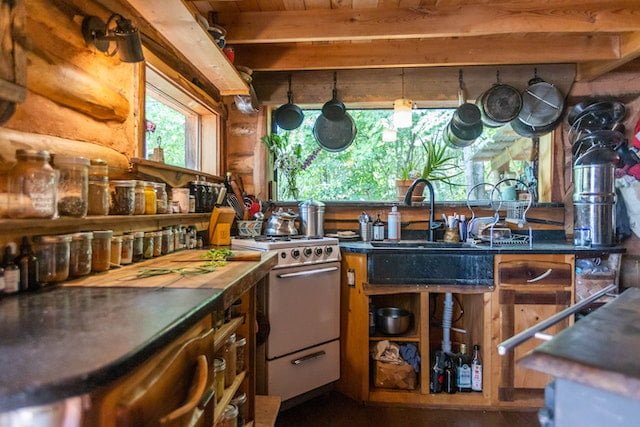 Interior of a small kitchen in a DIY custom not-so-tiny house built by Natalie Bogwalker of Wild Abundance