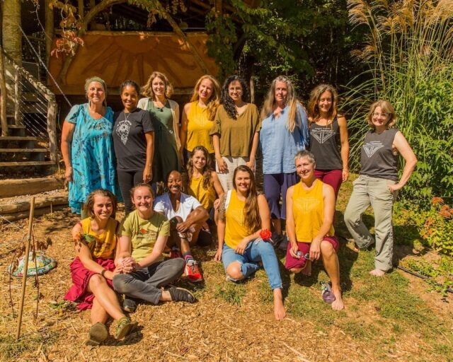 A group of women smile after the closing circle of their rewilding retreat at Wild Abundance