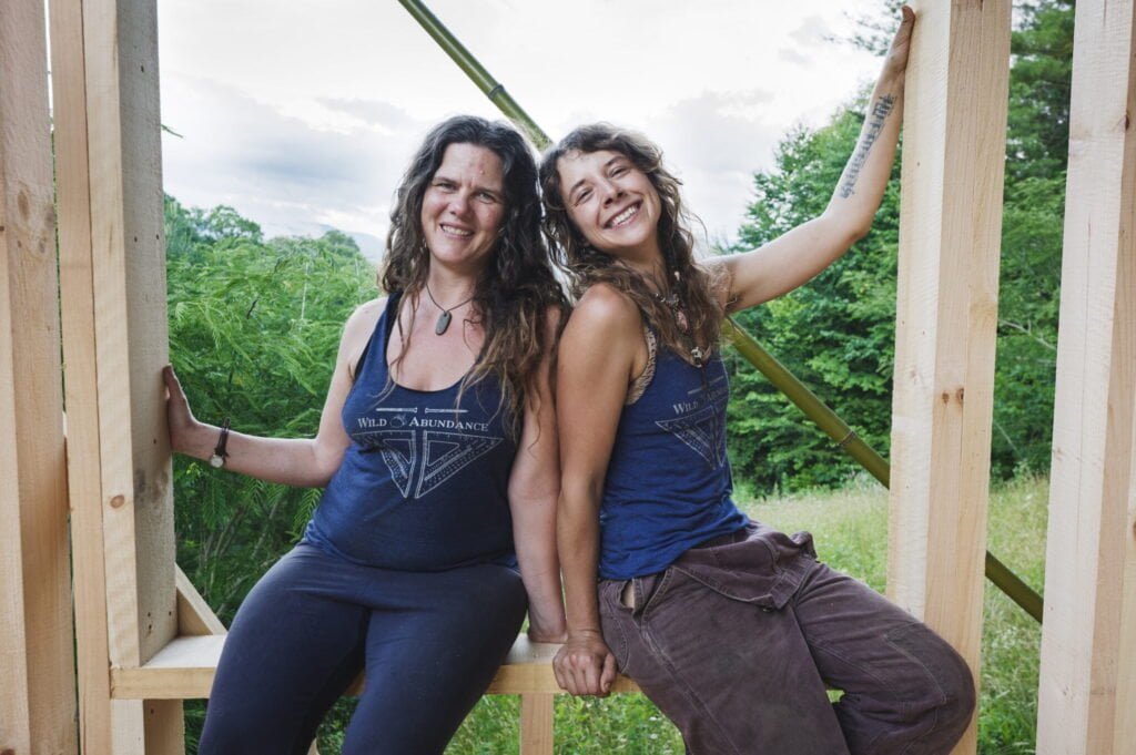 Nadi, an instructor for basic carpentry classes at Wild Abundance, smiling next to Natalie, the founder of Wild Abundance