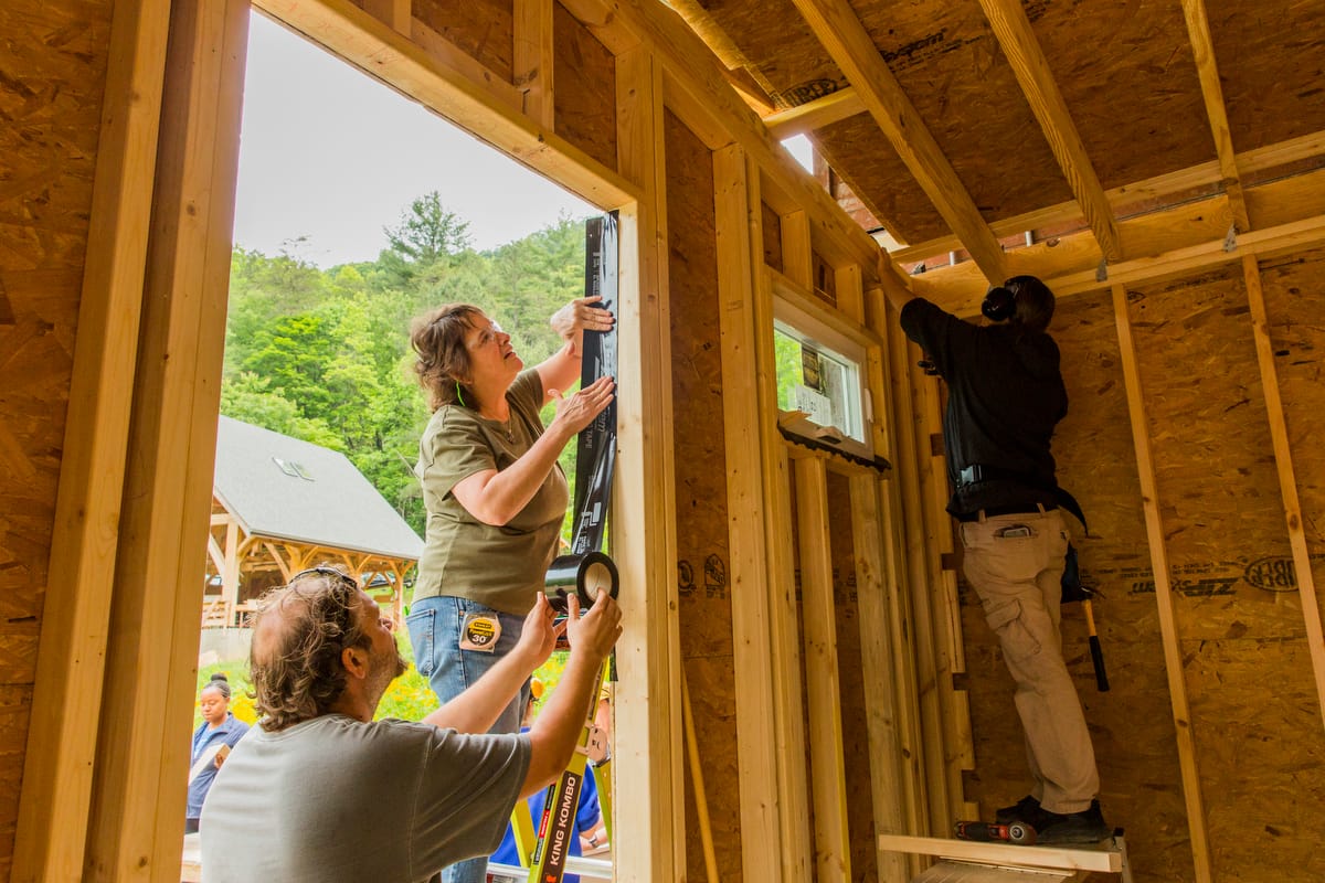 THIPW-1200-Current-82 Students prepare door and window rough openings for the installation of a door and windows during a Tiny House Building Workshop at Wild Abundance in North Carolina