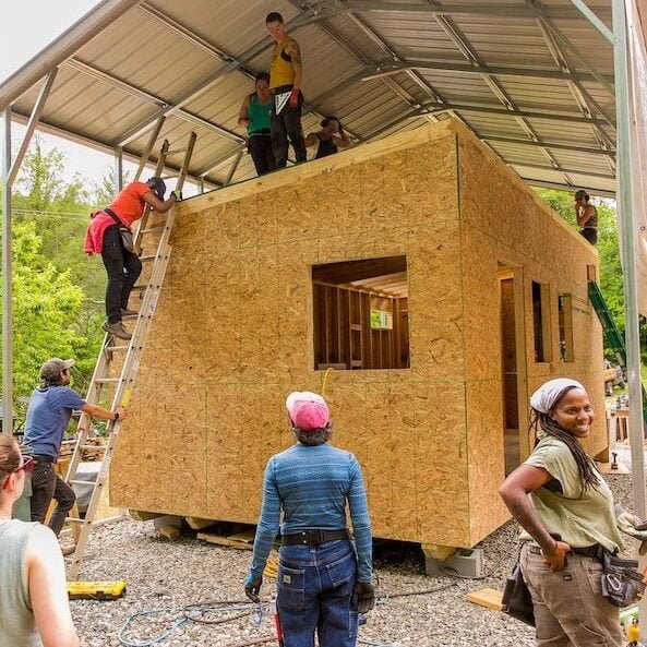A group of students seen learning how to build a tiny house at a carpentry workshop at Wild Abundance