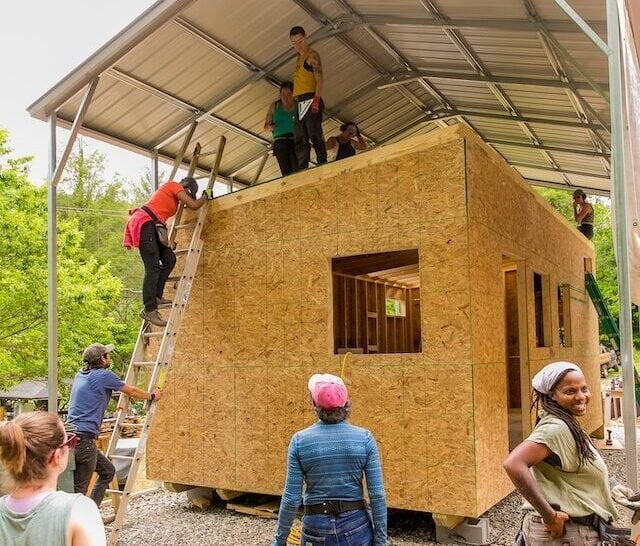 students around a tiny house building project at Wild Abundance's Paint Fork Campus