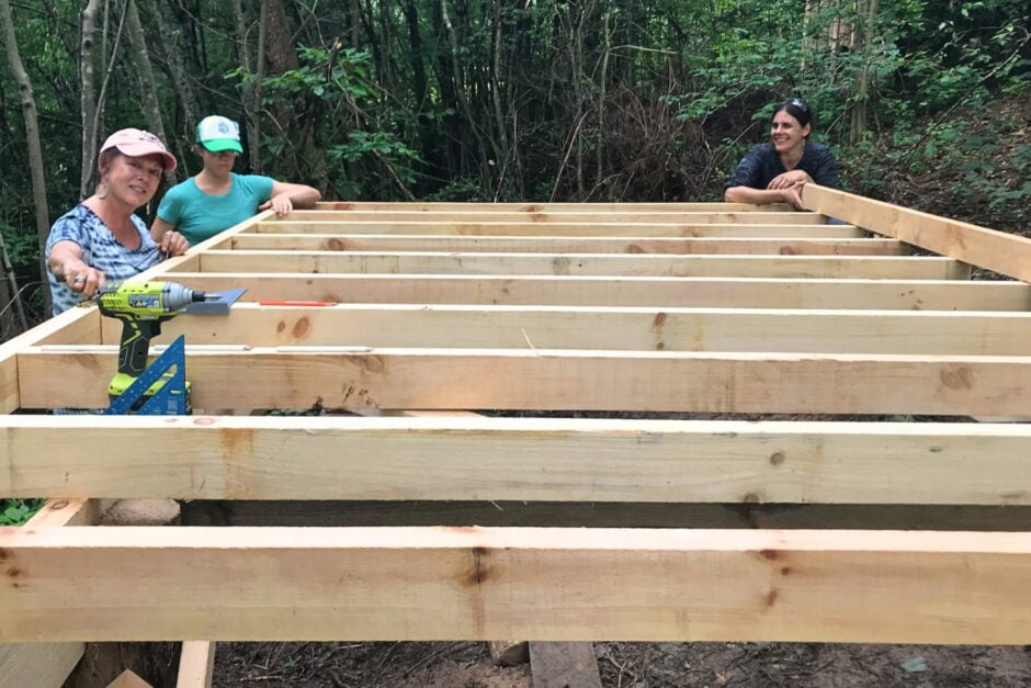 carpentry students building a floor system for a small shed structure