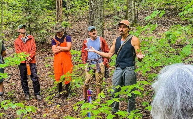 Luke Learningdeer, guest instructor at a PDC, takes students through the forest for tree identification and discussion of working to support the local ecosystems with permaculture