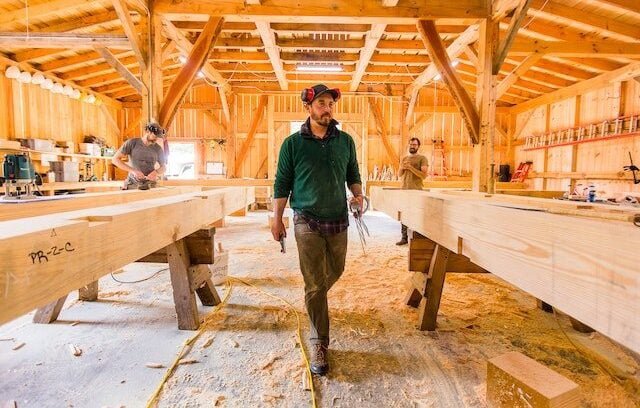 Brian Snedecker, the instructor, walks through the Timber Framing shop during a workshop for Wild Abundance