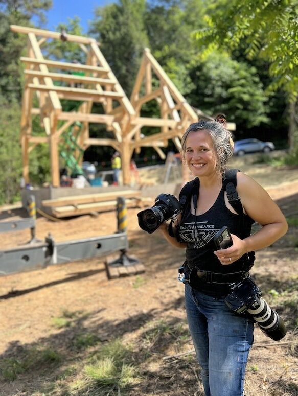 Photographer Sarah Tew smiles while capturing a build at the Wild Abundance campus