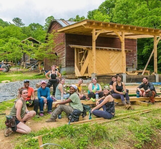 A tiny house building class hanging out during a lunch break at the new Wild Abundance carpentry and building workshop campus in Barnardsville, NC