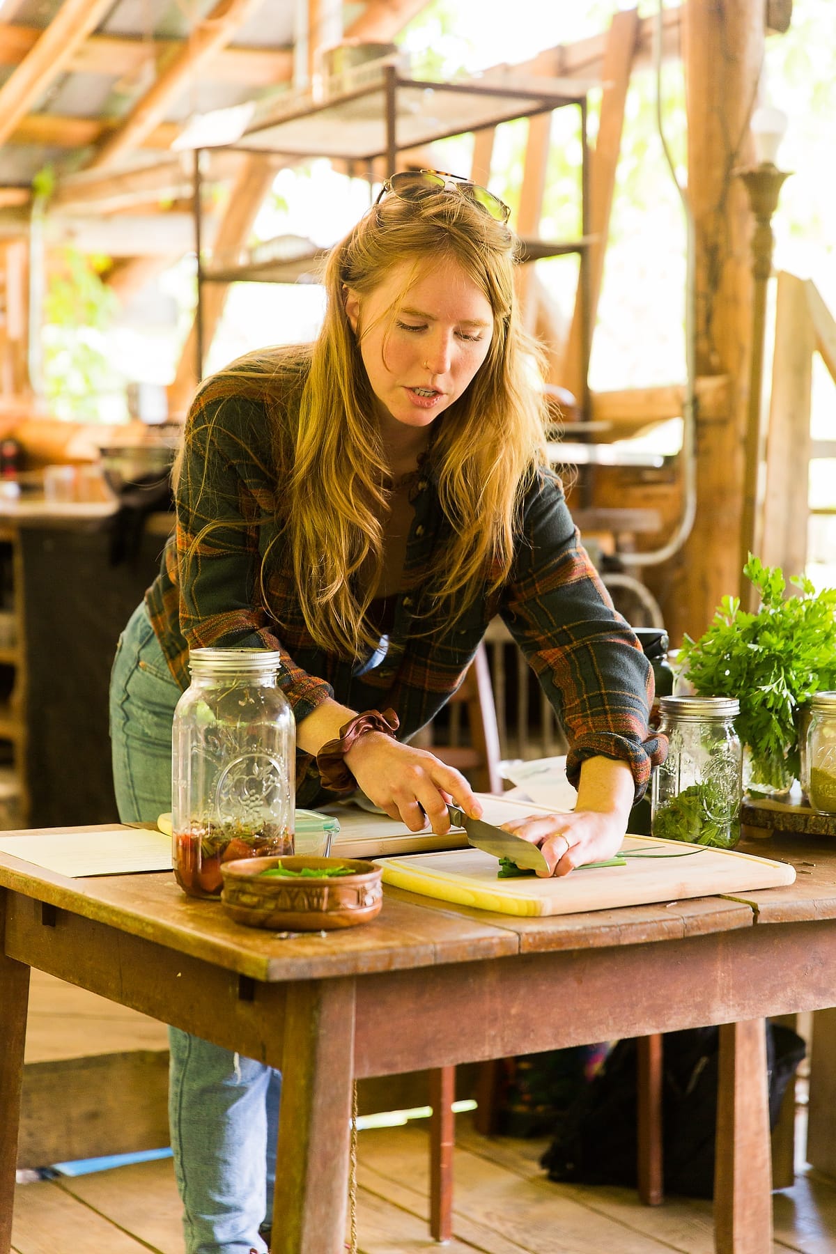 Kearsley Tate Schweller demonstraies proper chopping techniques as she teaches knife skills and safety in the Nourishing Foods cooking class for women at Wild Abundance