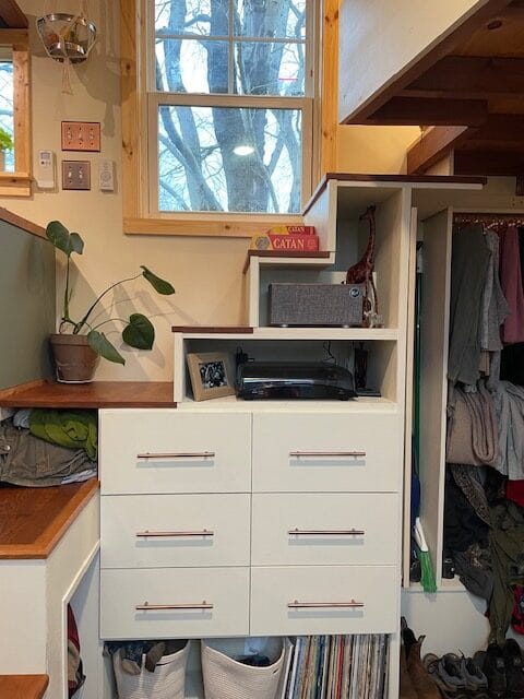 Under stair storage in Forest's Tiny House Storage system built in under the stairs to a loft in a Tiny Home built during a Wild Abundance tiny home construction workshop