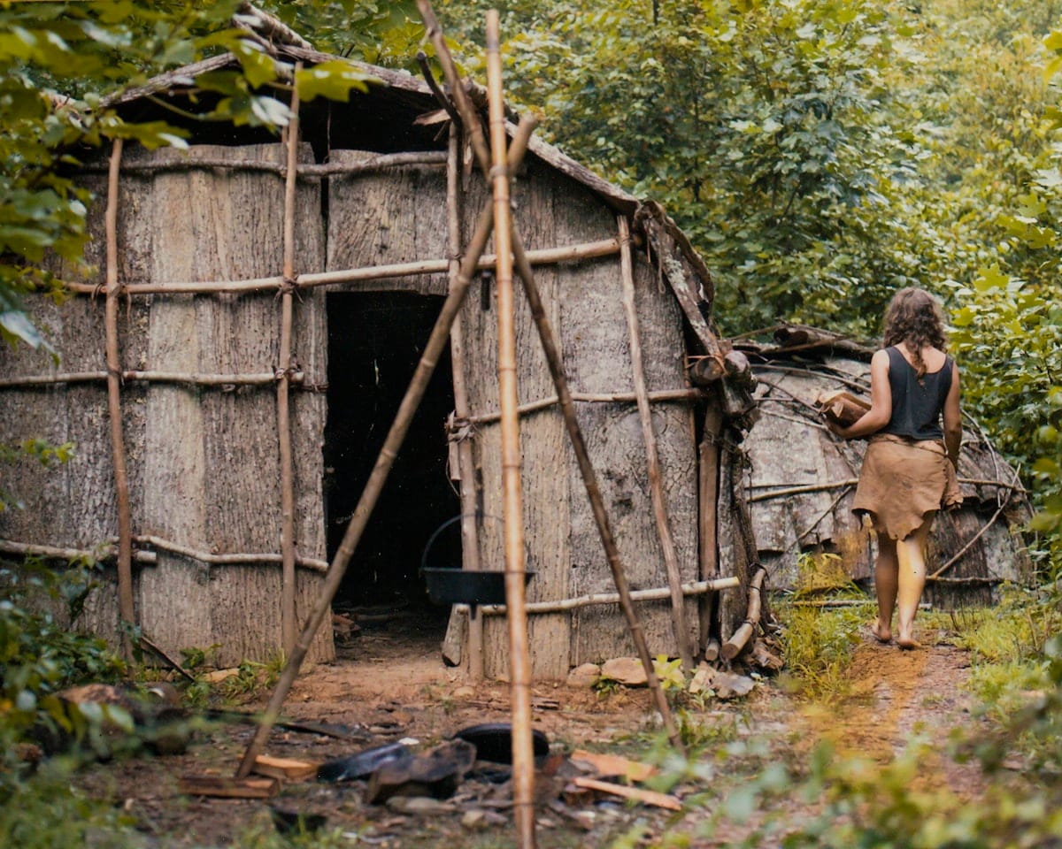 Natalie early life history young--bark hut wild roots-Natalie with bark hut Natalie Bogwalker with the bark hut she built at Wild Roots as a young woman