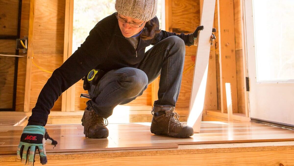 17-Handy Homeowner Bootcamp 2025 A student learns to install hardwood flooring in the Handy Homeowner bootcamp at Wild Abundance