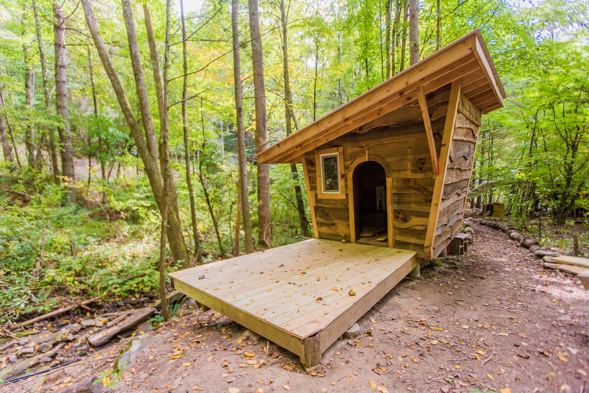 A sauna availabe for students overlooks a stream running gently through the forested campground of Wild Abundance's DIY skills school campus, where students can always bring a tent and use the shared facilities if they don't want to rent an airbnb or other lodging during their class.