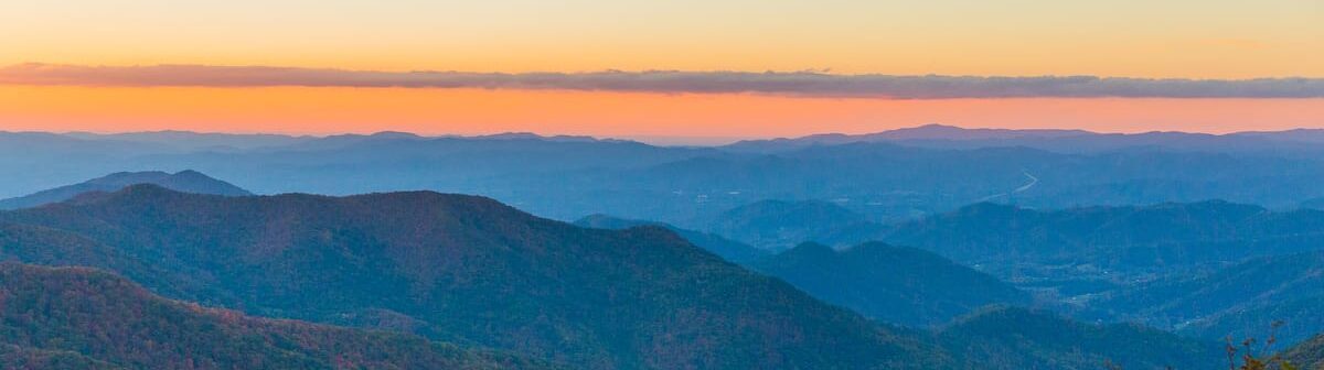 The sun sets over the Blue Ridge Mountains in Western North Carolina, a short drive from the campus of DIY Skills school Wild Abundance