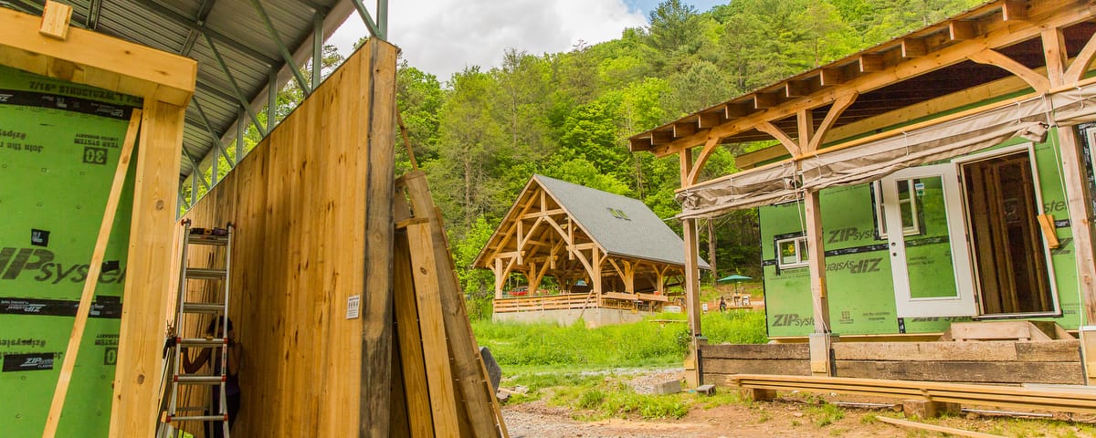 Multiple tiny homes are seen in stages of the building process at the campus of Wild Abudance in North Carolina